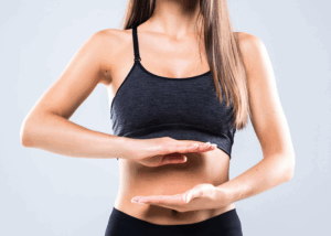 beautiful portrait woman hand gesture heart shape belly girl wearing sport clothing with exercising isolated white 2